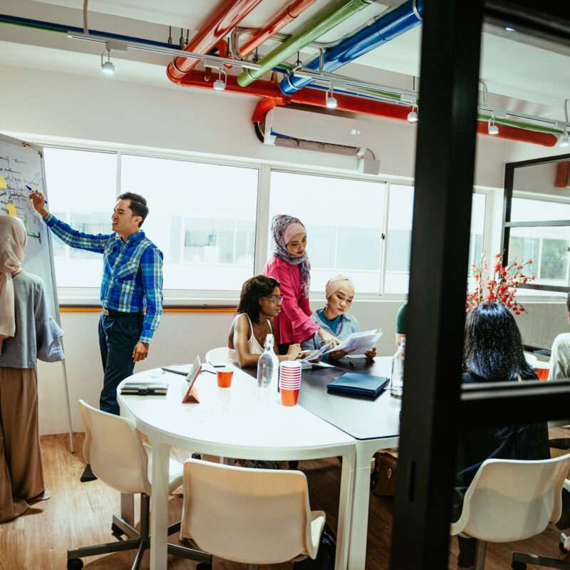 Multi ethnic business team in office developing new crowdfunded project