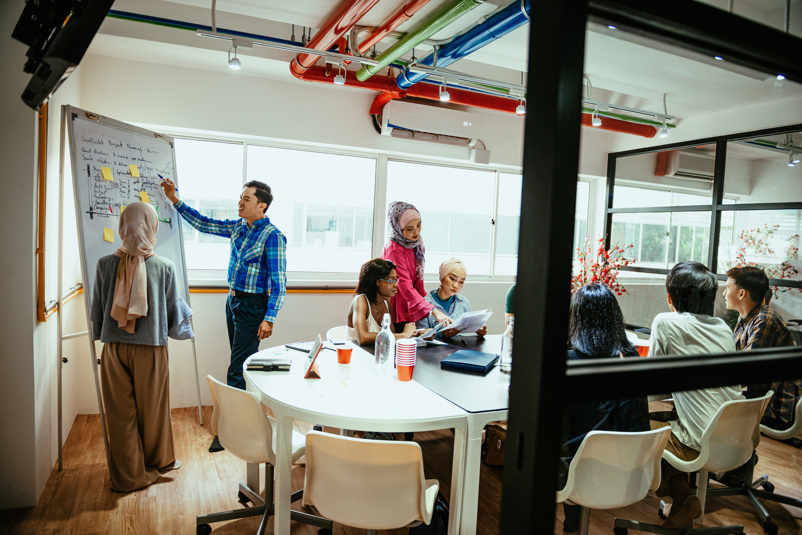 Multi ethnic business team in office developing new crowdfunded project